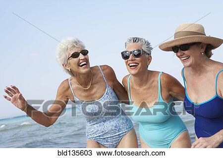 Senior women walking on beach View Large Photo Image Stock Image - Senior women walking on beach. Fotosearch