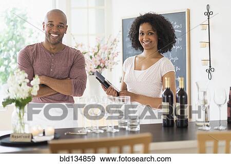 Stock Photo - Servers smiling in restaurant. Fotosearch