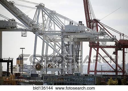 Shipping cranes in industrial harbor View Large Photo Image Picture - Shipping cranes in industrial harbor. Fotosearch
