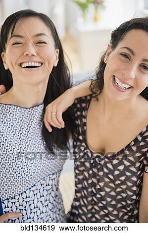 Smiling women standing together View Large Photo Image Stock Photo - Smiling women standing together. Fotosearch