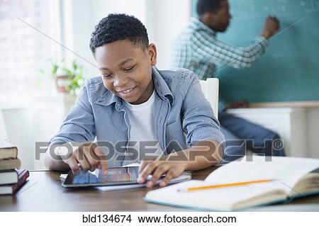 Student using tablet computer in classroom View Large Photo Image Picture - Student using tablet computer in classroom. Fotosearch