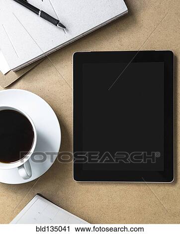 Tablet computer on table with book and coffee View Large Photo Image Stock Image - Tablet computer on table with book and coffee. Fotosearch