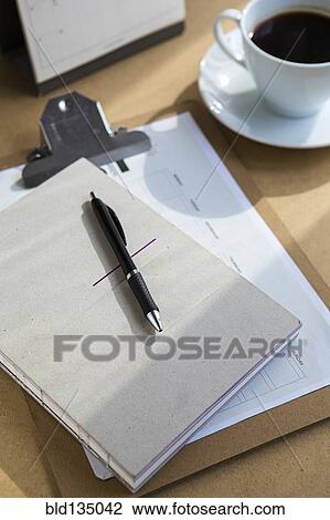 Tablet computer on table with books and cup of coffee View Large Photo Image Stock Image - Tablet computer on table with books and cup of coffee. Fotosearch