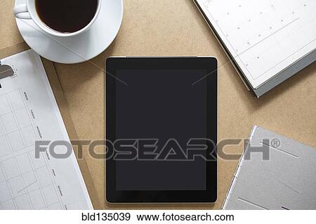Stock Photo - Tablet computer on table with clipboard and coffee. Fotosearch
