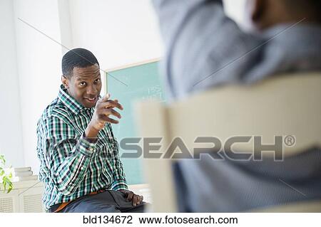 Teacher pointing at student in classroom View Large Photo Image Stock Image - Teacher pointing at student in classroom. Fotosearch