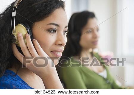 Teenage girl listening to headphones View Large Photo Image Stock Image - Teenage girl listening to headphones. Fotosearch