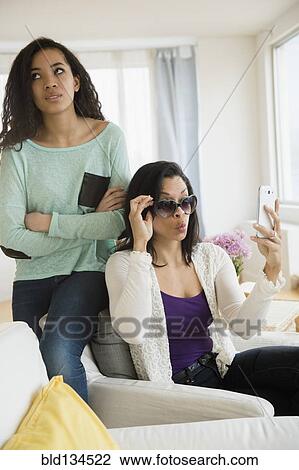 Teenage girl rolling her eyes at mother View Large Photo Image Stock Image - Teenage girl rolling her eyes at mother. Fotosearch