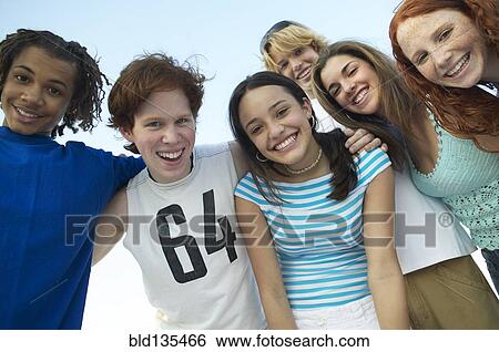 Teenagers standing together outdoors View Large Photo Image Stock Photograph - Teenagers standing together outdoors. Fotosearch