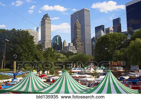 Tents and fair in urban park View Large Photo Image Stock Photography - Tents and fair in urban park. Fotosearch