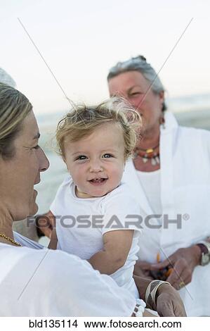 Three generations of Caucasian family on beach View Large Photo Image Picture - Three generations of Caucasian family on beach. Fotosearch
