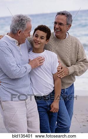 Three generations of Caucasian men walking on beach View Large Photo Image Stock Image - Three generations of Caucasian men walking on beach. Fotosearch