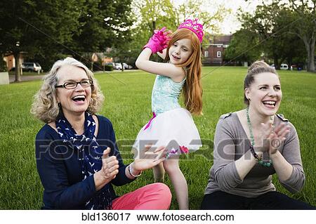 Stock Photo - Three generations of Caucasian women relaxing in park. Fotosearch