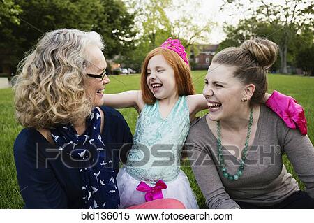 Three generations of Caucasian women sitting in park View Large Photo Image Stock Photography - Three generations of Caucasian women sitting in park. Fotosearch