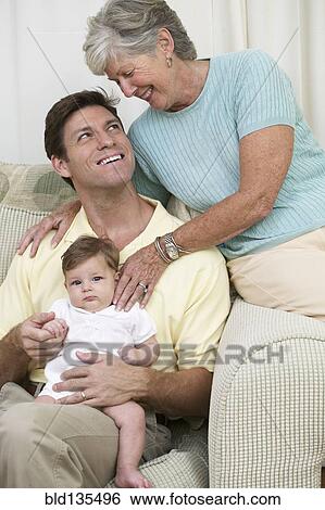 Three generations of family on sofa View Large Photo Image Stock Photograph - Three generations of family on sofa. Fotosearch