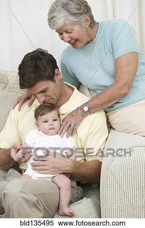 Three generations of family on sofa View Large Photo Image Stock Photography - Three generations of family on sofa. Fotosearch