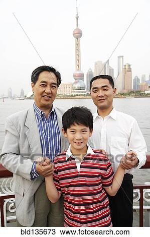 Three generations of men smiling by city skyline, Shanghai, China View Large Photo Image Stock Image - Three generations of men smiling by city skyline, Shanghai, China. Fotosearch