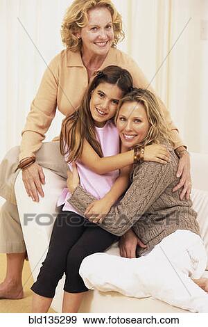 Stock Photo - Three generations of women hugging. Fotosearch