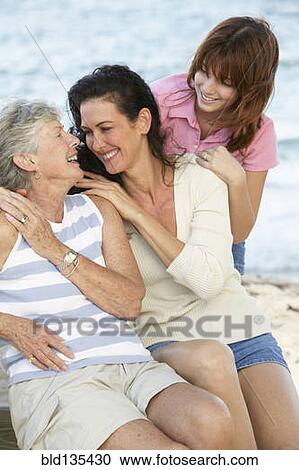 Three generations of women smiling outdoors View Large Photo Image Stock Image - Three generations of women smiling outdoors. Fotosearch