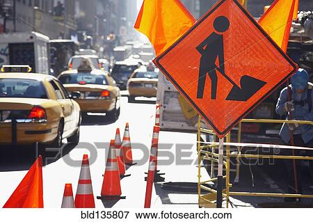Traffic cones and sign on city street View Large Photo Image Stock Photo - Traffic cones and sign on city street. Fotosearch