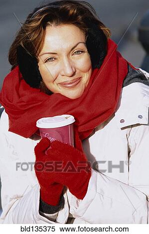 Stock Photography - Woman drinking coffee outdoors. Fotosearch