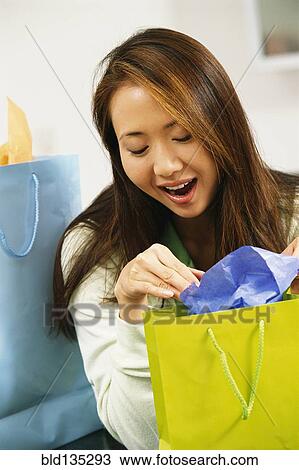 Woman opening presents View Large Photo Image Stock Image - Woman opening presents. Fotosearch
