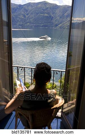Woman overlooking rural lake from balcony, Lugano, Ticino, Switzerland View Large Photo Image Stock Image - Woman overlooking rural lake from balcony, Lugano, Ticino, Switzerland. Fotosearch