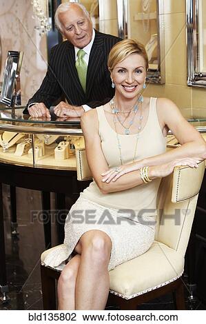 Woman smiling in jewelry store View Large Photo Image Stock Image - Woman smiling in jewelry store. Fotosearch