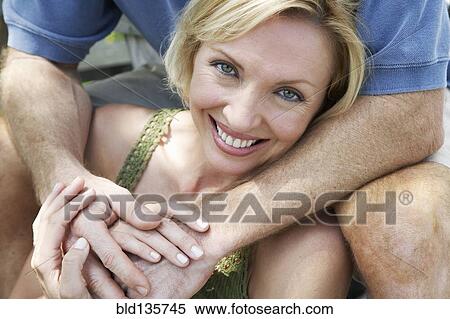 Woman smiling on wooden patio View Large Photo Image Stock Photography - Woman smiling on wooden patio. Fotosearch