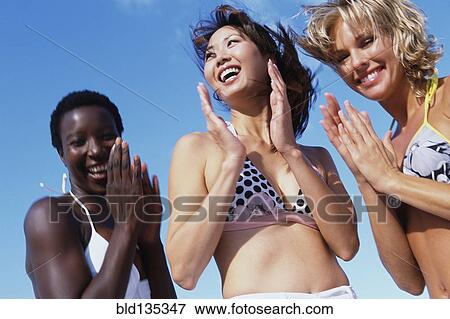 Women clapping together on beach View Large Photo Image Stock Photo - Women clapping together on beach. Fotosearch
