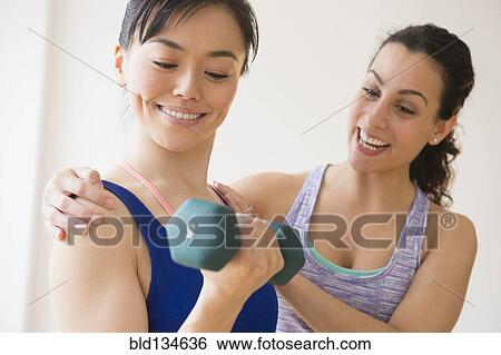 Women exercising together in gym View Large Photo Image Stock Photograph - Women exercising together in gym. Fotosearch