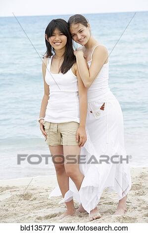 Women hugging on beach View Large Photo Image Stock Photo - Women hugging on beach. Fotosearch
