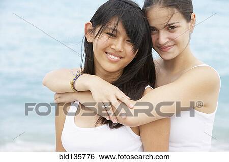 Women hugging outdoors View Large Photo Image Stock Photograph - Women hugging outdoors. Fotosearch