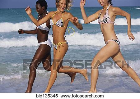 Women running together on beach View Large Photo Image Stock Photography - Women running together on beach. Fotosearch