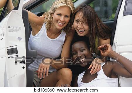 Women smiling together in car View Large Photo Image Stock Image - Women smiling together in car. Fotosearch