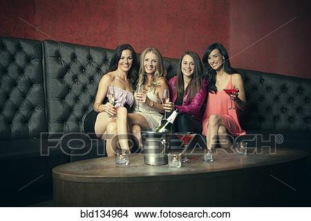 Women smiling together in nightclub View Large Photo Image Picture - Women smiling together in nightclub. Fotosearch