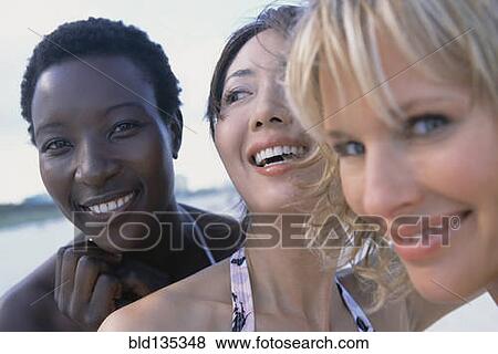 Women smiling together on beach View Large Photo Image Stock Photo - Women smiling together on beach. Fotosearch