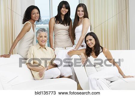 Women smiling together on sofa View Large Photo Image Stock Image - Women smiling together on sofa. Fotosearch