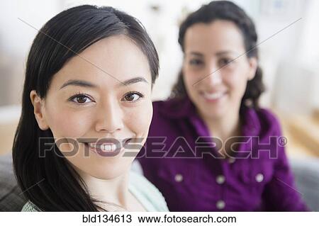 Stock Image - Women smiling together. Fotosearch