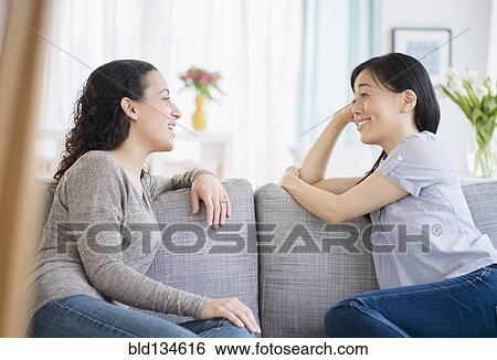 Women talking on sofa View Large Photo Image Stock Photograph - Women talking on sofa. Fotosearch