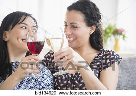 Women toasting each other with wine View Large Photo Image Stock Image - Women toasting each other with wine. Fotosearch
