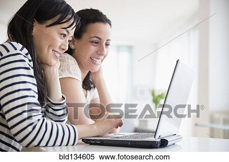 Women using laptop together View Large Photo Image Stock Photography - Women using laptop together. Fotosearch