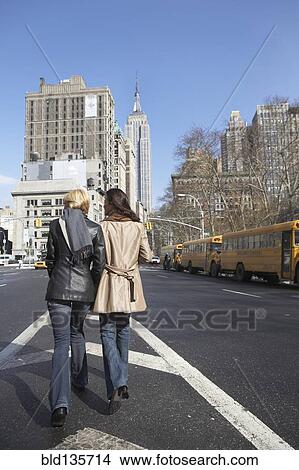 Picture - Women walking together on city street. Fotosearch