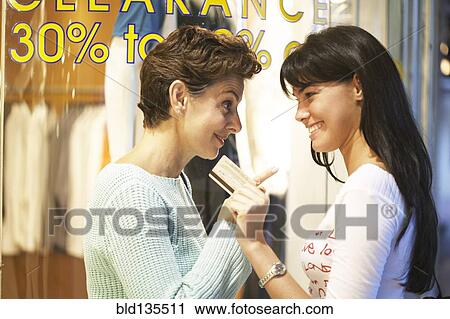 Women window shopping together on city street View Large Photo Image Stock Image - Women window shopping together on city street. Fotosearch