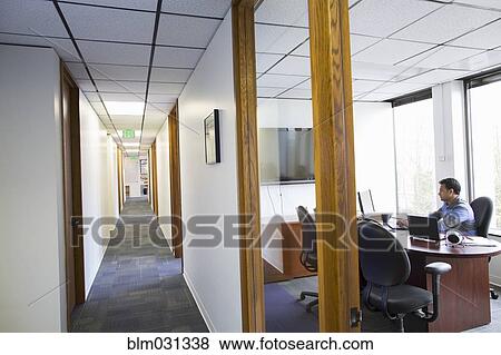 Stock Photo - Asian businessman working in office. Fotosearch
