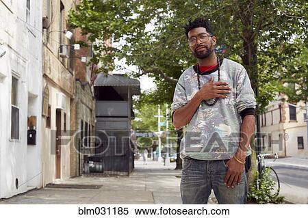 Stock Photography - Black man standing on city street. Fotosearch