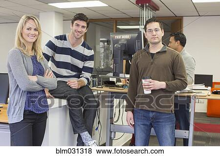 Stock Photo - Business people smiling in office. Fotosearch