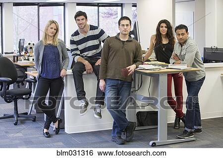 Business people smiling in office View Large Photo Image Stock Photograph - Business people smiling in office. Fotosearch
