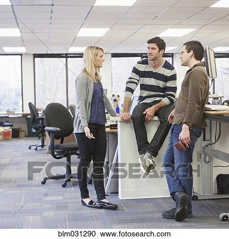 Stock Image - Business people talking in office. Fotosearch