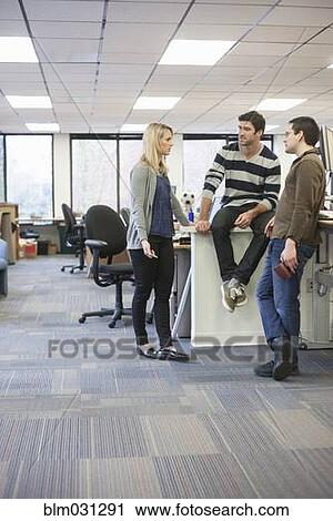 Stock Image - Business people talking in office. Fotosearch