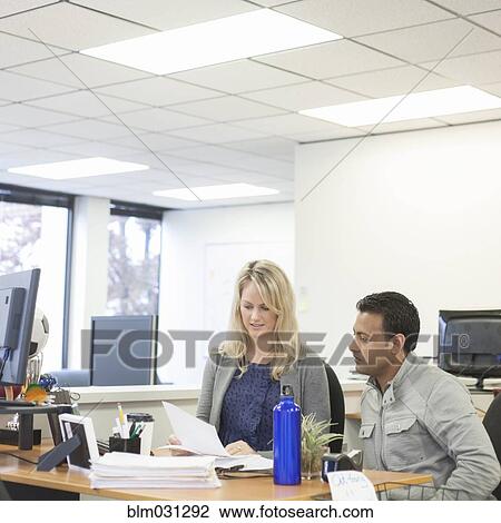 Stock Image - Business people talking in office. Fotosearch